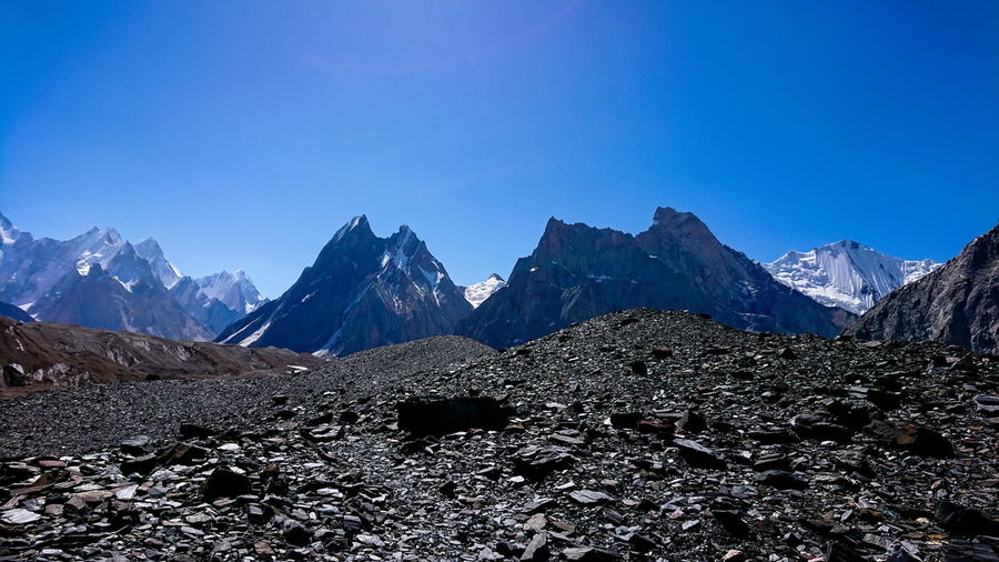 Scenic view of snowcapped mountains against clear blue sky