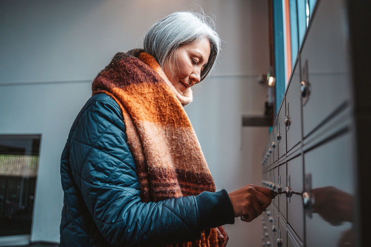 Side view of woman opening lock