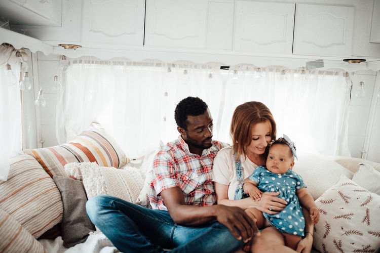 Cheerful family siting in camper van
