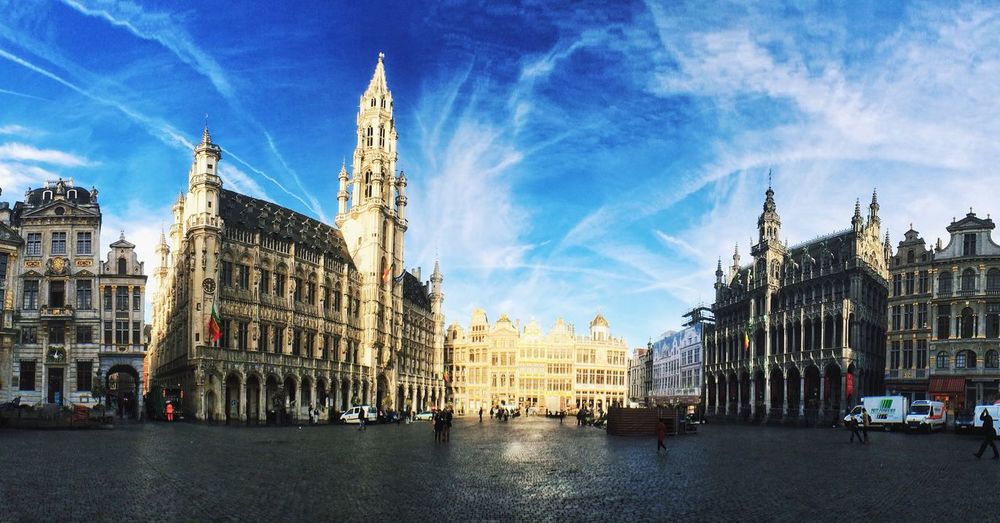 Buildings in city against cloudy sky