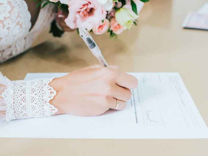 The bride signs the marriage document