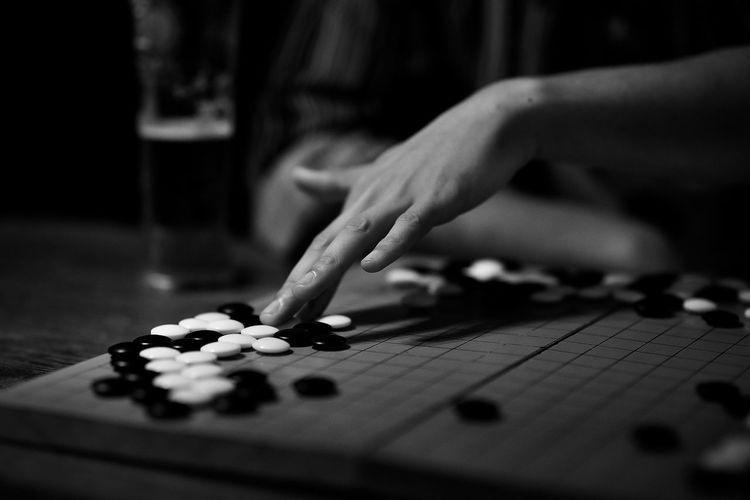Cropped hand of woman playing tabletop game