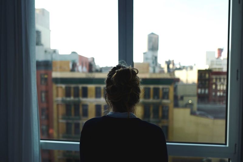 Rear view of a woman looking through cityscape