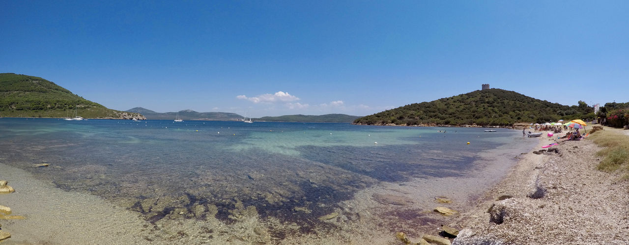 Scenic view of beach against blue sky