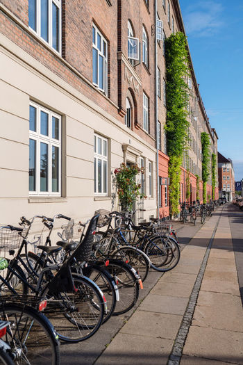 Bicycles on street by buildings in city