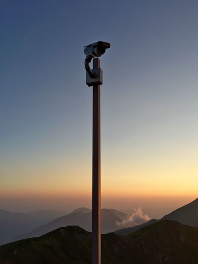 Security camera against mountains during sunset
