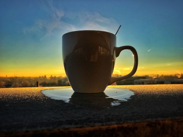 Close-up of tea cup against sky