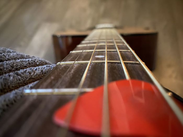 Close-up of guitar on hardwood floor