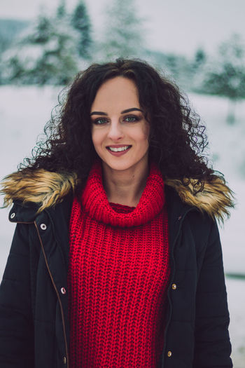 Portrait of smiling young woman standing outdoors