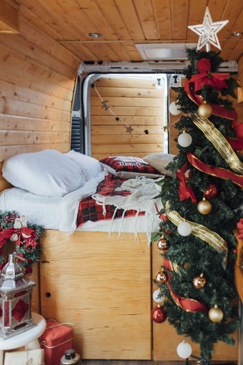 Christmas tree by bed in camper van
