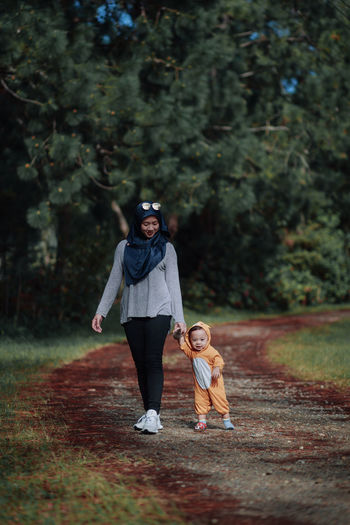 Full length of woman walking on footpath