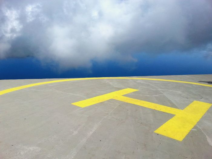 High angle view of helipad against cloudy sky