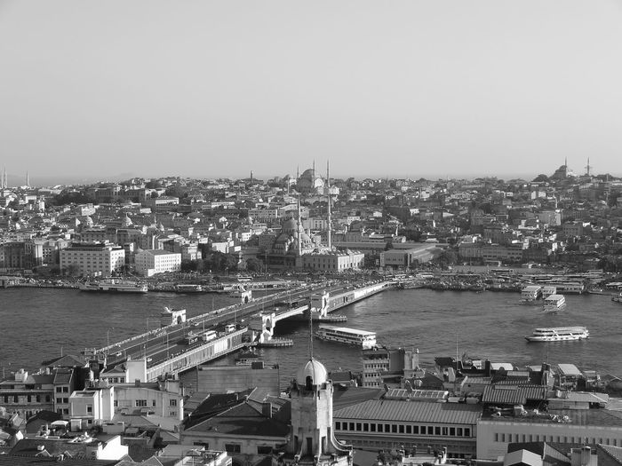 Aerial view of strait amidst buildings against clear sky