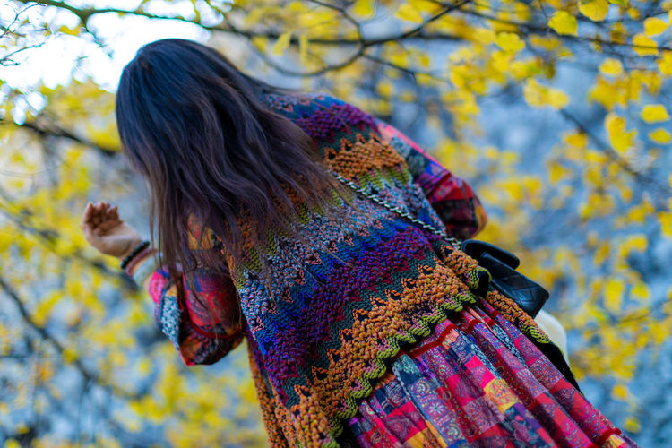 Rear view of woman with umbrella during autumn