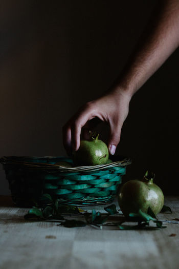 Person taking fruit from basket