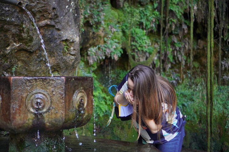 Side view of a woman drinking water