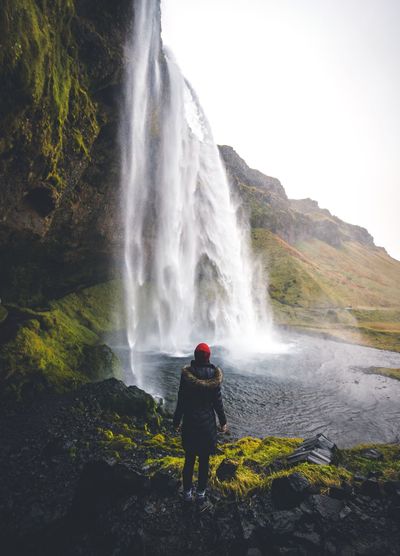 Scenic view of waterfall against sky