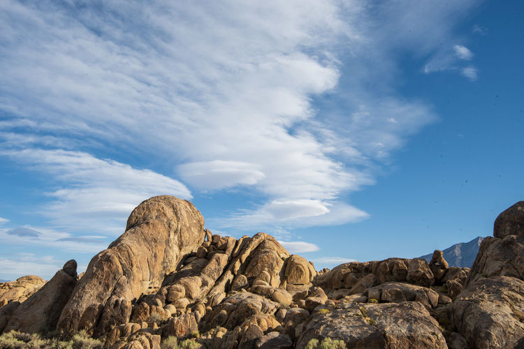 Low angle view of rock formations against sky with sierra wave lenticular clouds