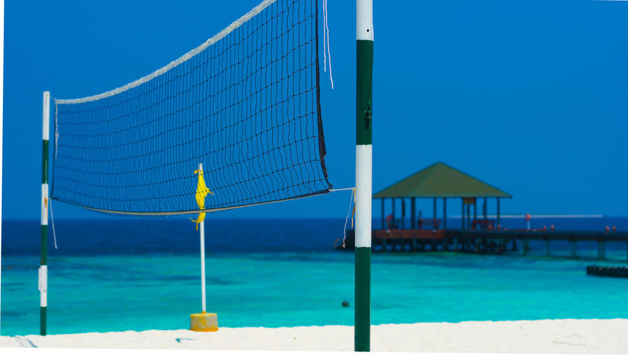 Built structure on beach against clear blue sky