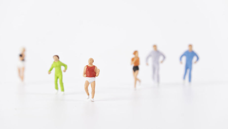 Rear view of people walking against white background