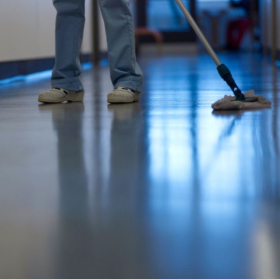 Low section of man cleaning floor