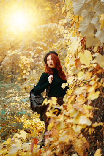 Young woman in autumn leaves