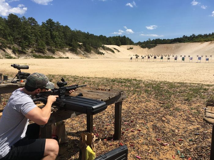 Man practicing with rifle at shooting range