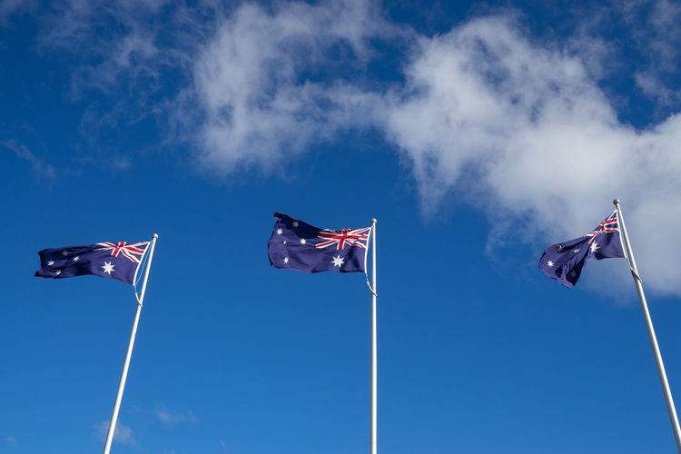 Low angle view of australian flag against blue sky