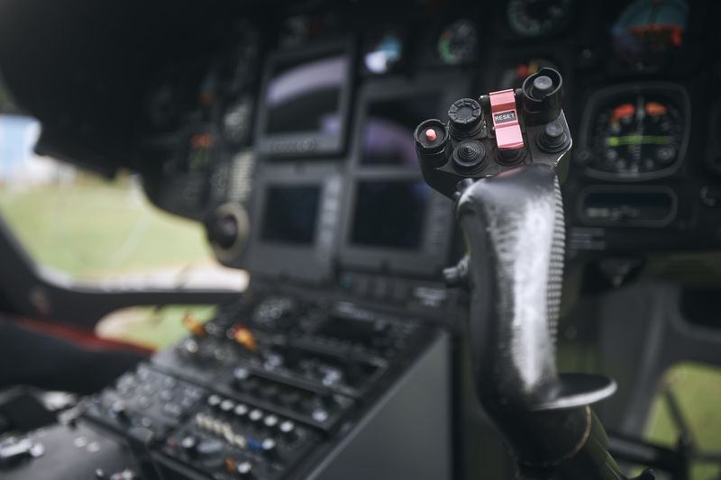 Close-up of helicopter flight control inside cockpit.