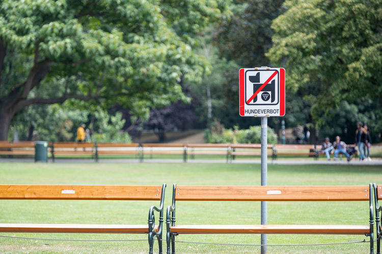 Close-up of warning sign in public park