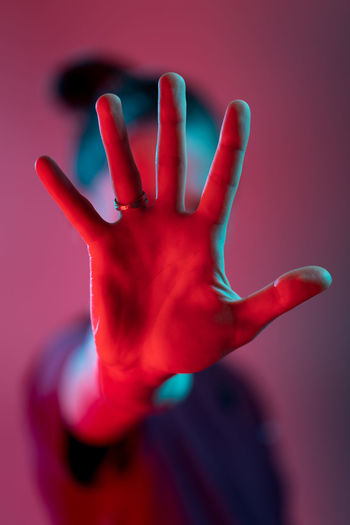 Close-up of hand against red background