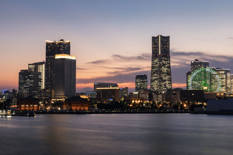 Minato mirai skyline during the sunset with the reflection in the sea. long exposure. golden hour