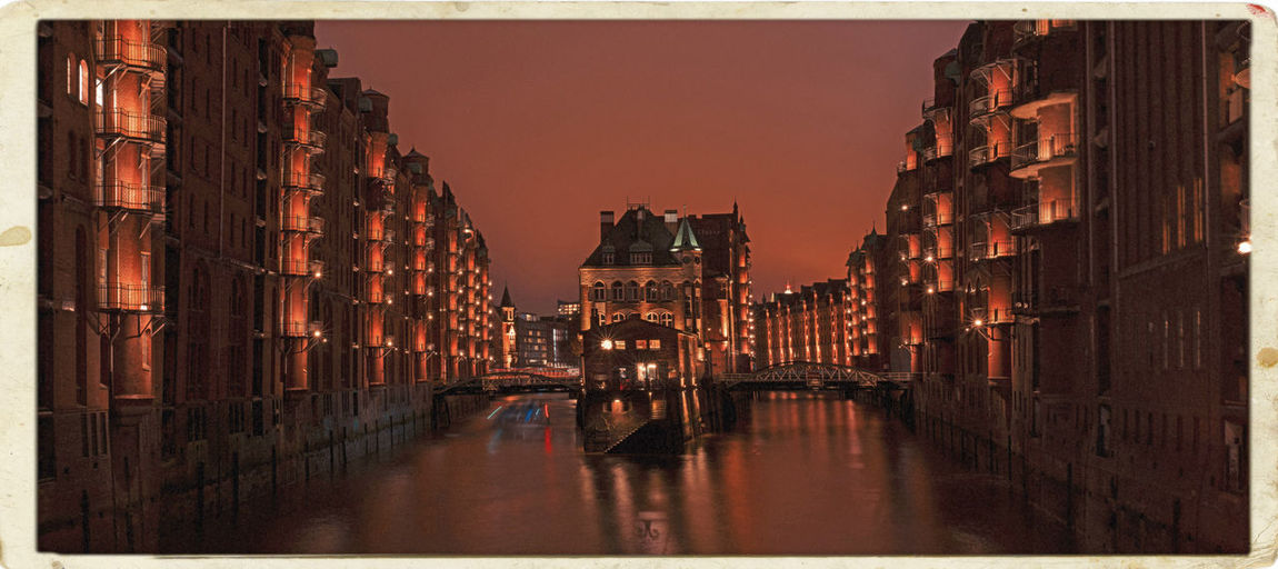 View of illuminated buildings at sunset
