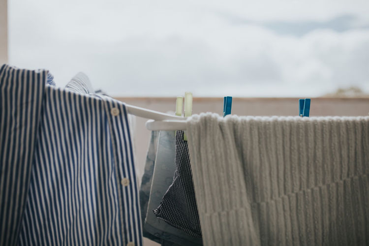 Close-up of clothing drying on clothesline in balcony