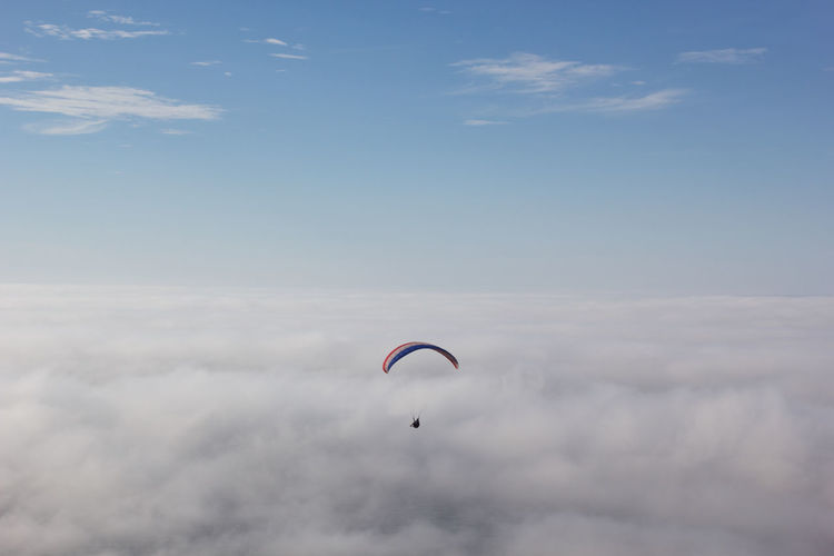 Parachute flying over cloudscape