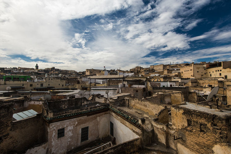 High angle shot of townscape against cloudy sky