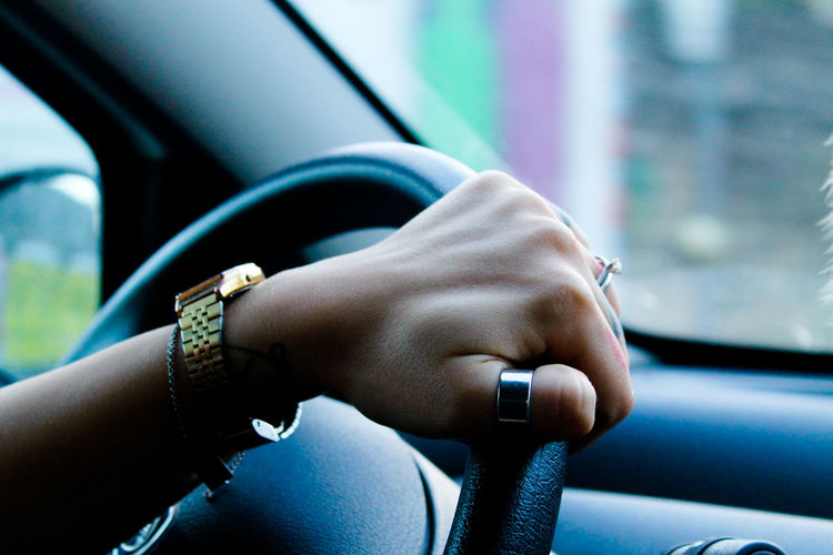 Cropped image of woman driving car