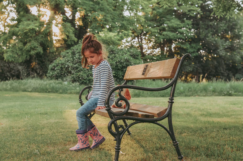 Full length of boy on bench in park