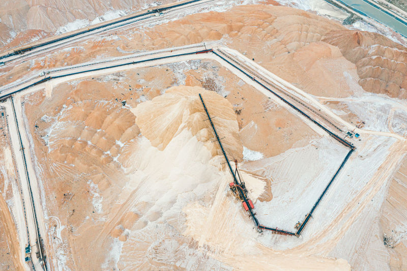 Mountains of salt and a crane upstairs. extraction of minerals.