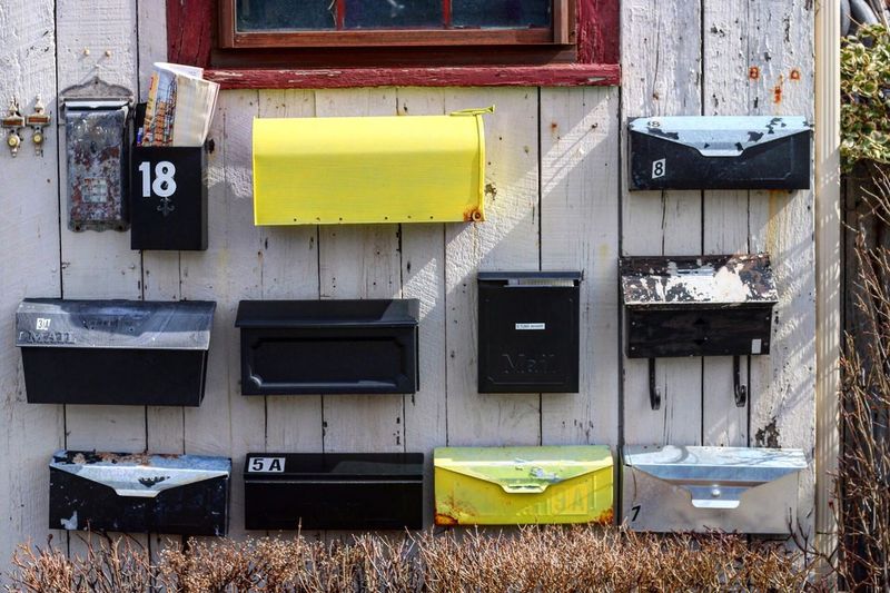 Yellow mailbox on abandoned wall