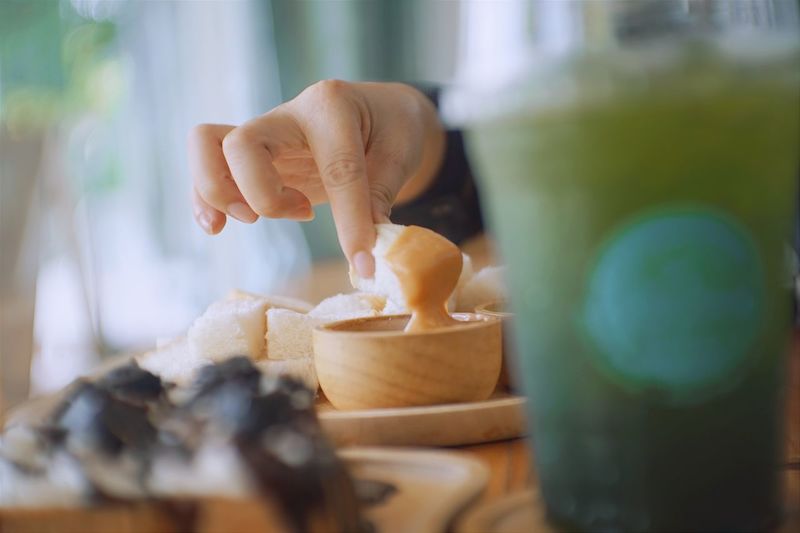 Close-up of hand holding ice cream at home