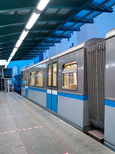 Moscow metro train at the station in the evening in blue colours