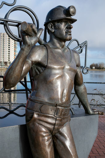 Close-up of statue against metal structure