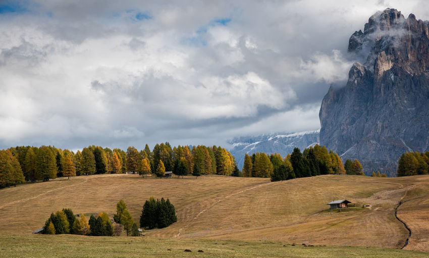 Landscape with beautiful autumn meadow field and the amazing dolomite rocky peaks. 