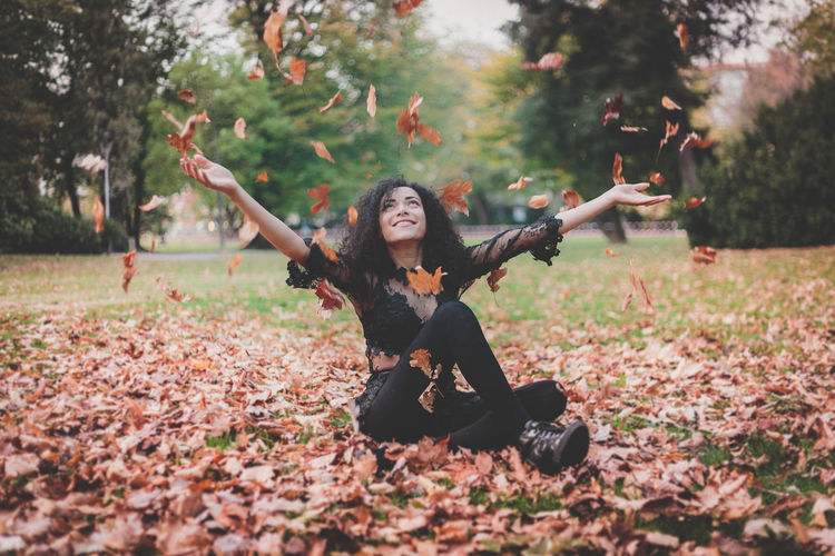 Full length portrait of young woman in park