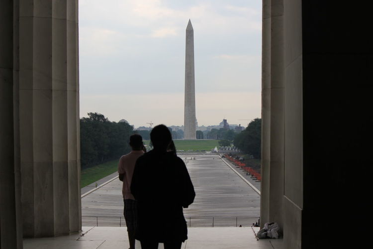 Rear view of man and woman looking at washington monument