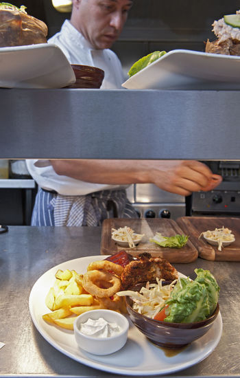 Pub food ready to be served in commercial kitchen at british pub