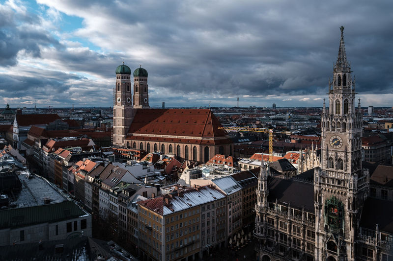 High angle view of buildings in munich city against cloudy sky, in view the frauenkirche