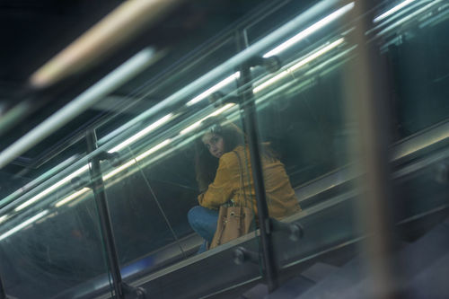 Young woman on escalator