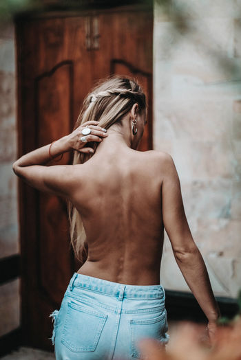 Blonde young model posing with her back. boho natural style. freedom concept. on vila island bali.